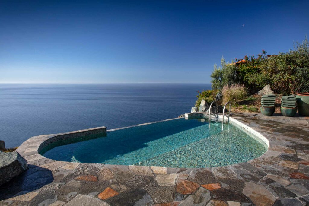 Outdoor pool at Post Ranch Inn with pacific ocean views.