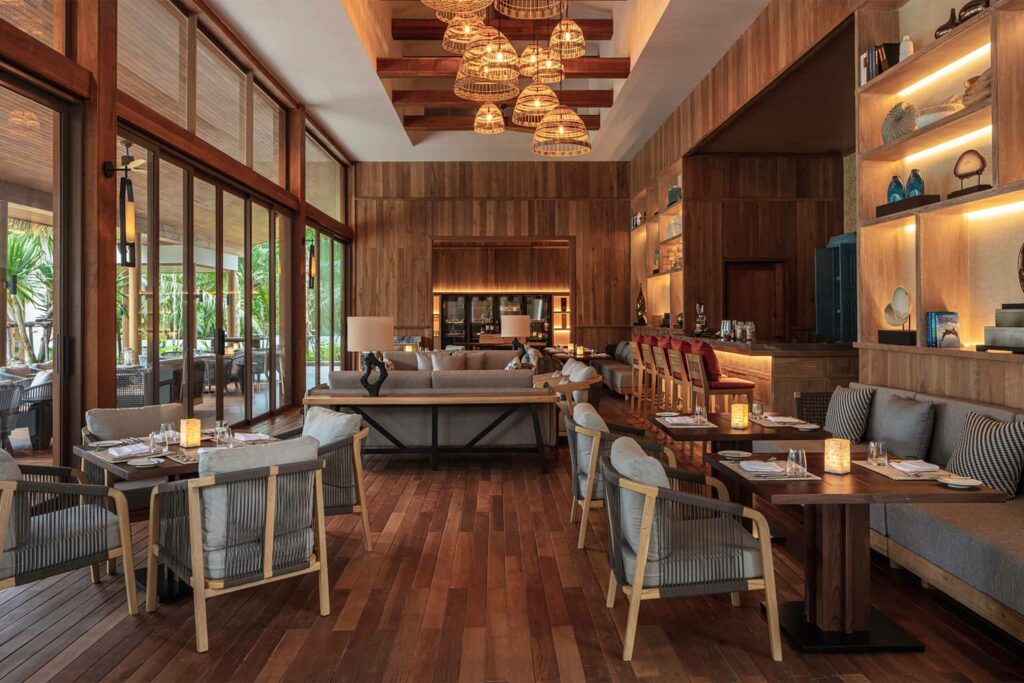 Pakarang restaurant interiors with wood flooring and wall art all around.