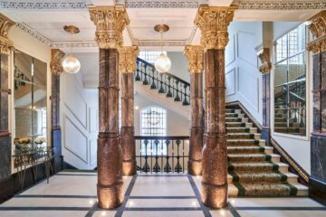 Staircase and bronze-coloured Corinthian pillars at The Grand Hotel Birmingham, United Kingdom.