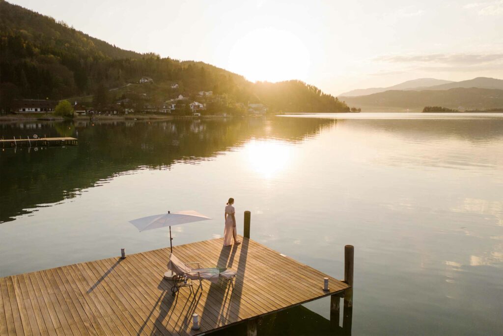 A guest looks out over the Lake Wörthersee, Austria