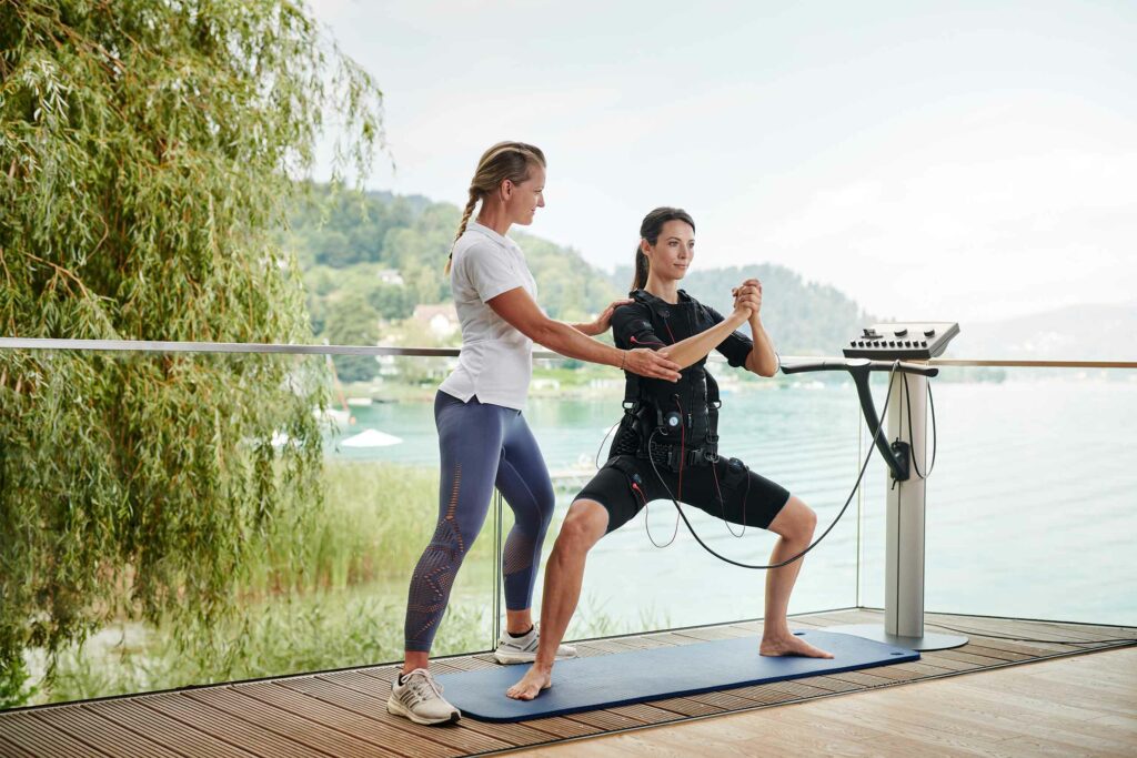 A guest enjoys a workout with a personal trainer in Maria Wörth, Lake Wörthersee, Austria