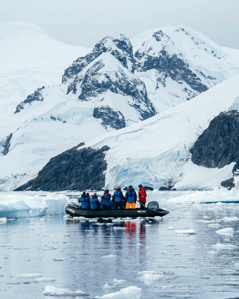 Travellers in a zodiac during an Antarctica Pride Cruise with AE Expeditions