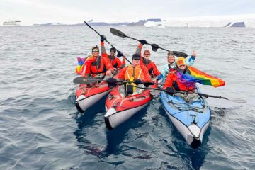 LGBTQ+ travellers on kayaks during an Antarctica Pride Cruise with AE Expeditions