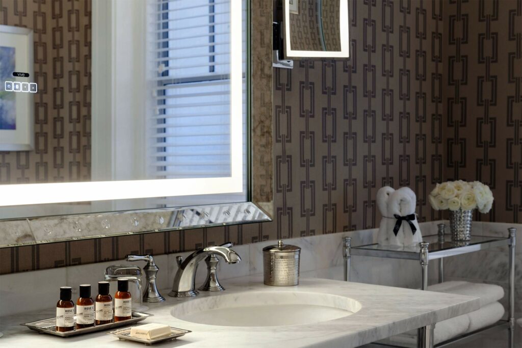 A sophisticated bathroom with muted colours and a marble basin. 