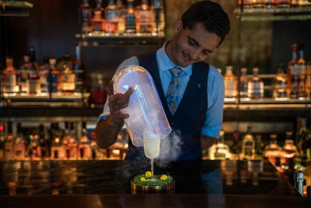 A barman mixes a cocktail at Grain, Australia