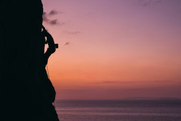 A rock climber climbs during sunset on Kalymnos, Greece