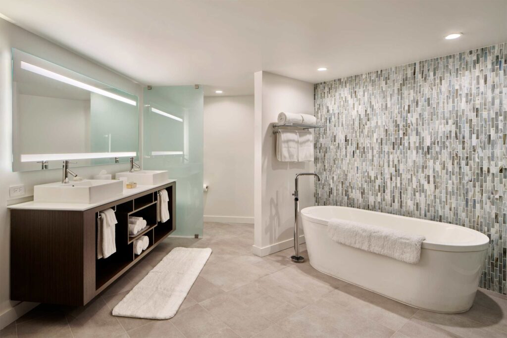 A mostly white bathroom with a freestanding bathtub. 