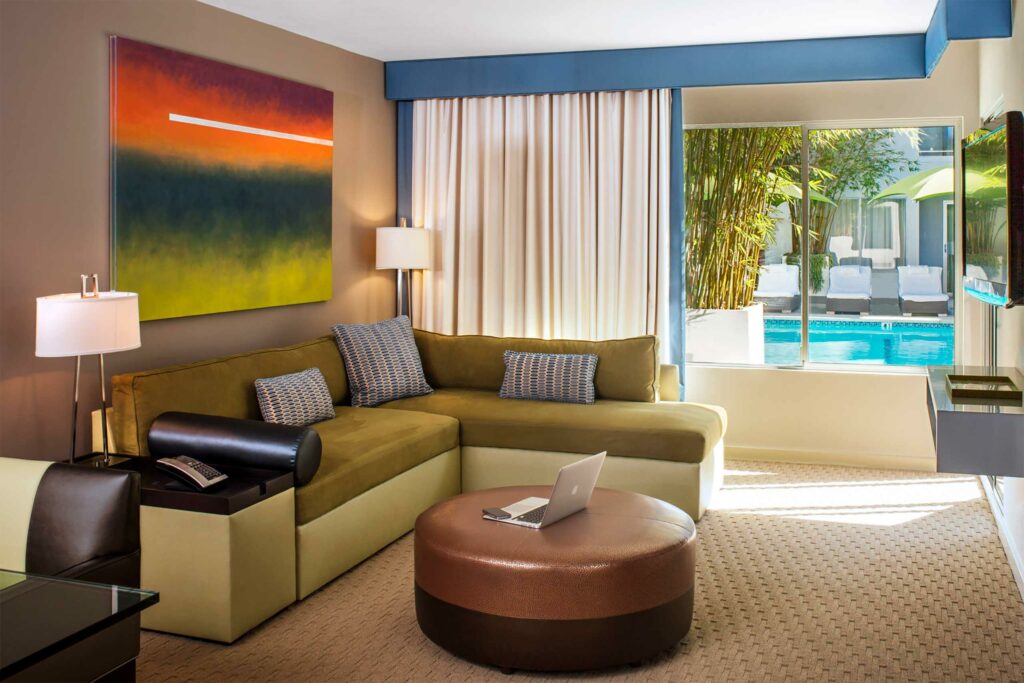 Vibrant suite living space with kaleidoscopic wall art at Sunset Marquis. 