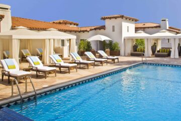 Outdoor pool and sun loungers at Sunset Marquis.