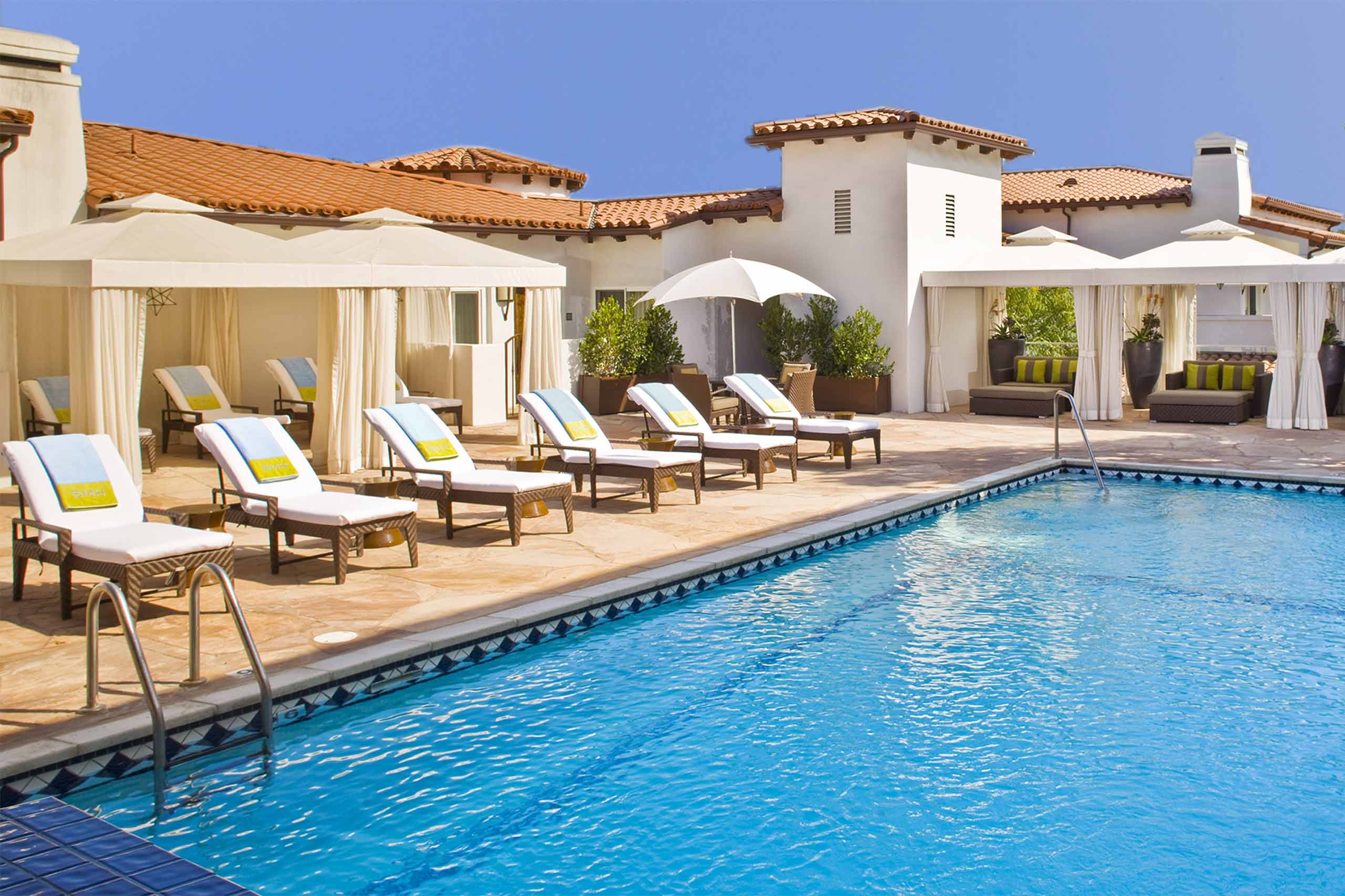 Outdoor pool and sun loungers at Sunset Marquis.