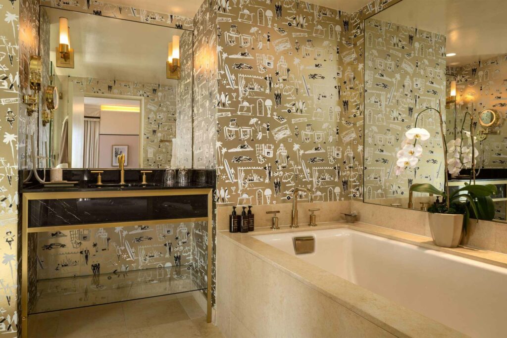 A golden bathroom with contemporary art-clad walls.