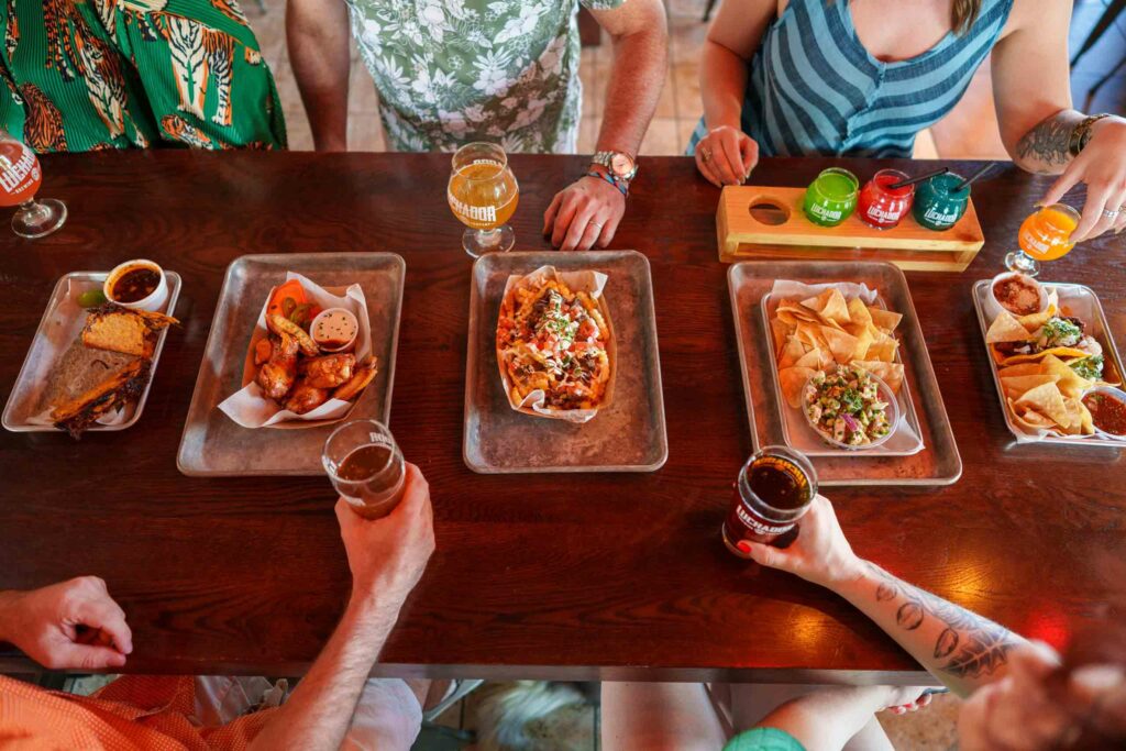 Table of food, drink and friends at the Luchador Brewing Company, Greater Palm Springs