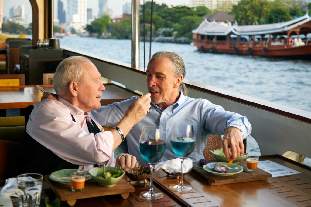 A gay couple enjoys a cruise in Bangkok. Thailand is one of the most exciting destinations for same-sex weddings in 2024