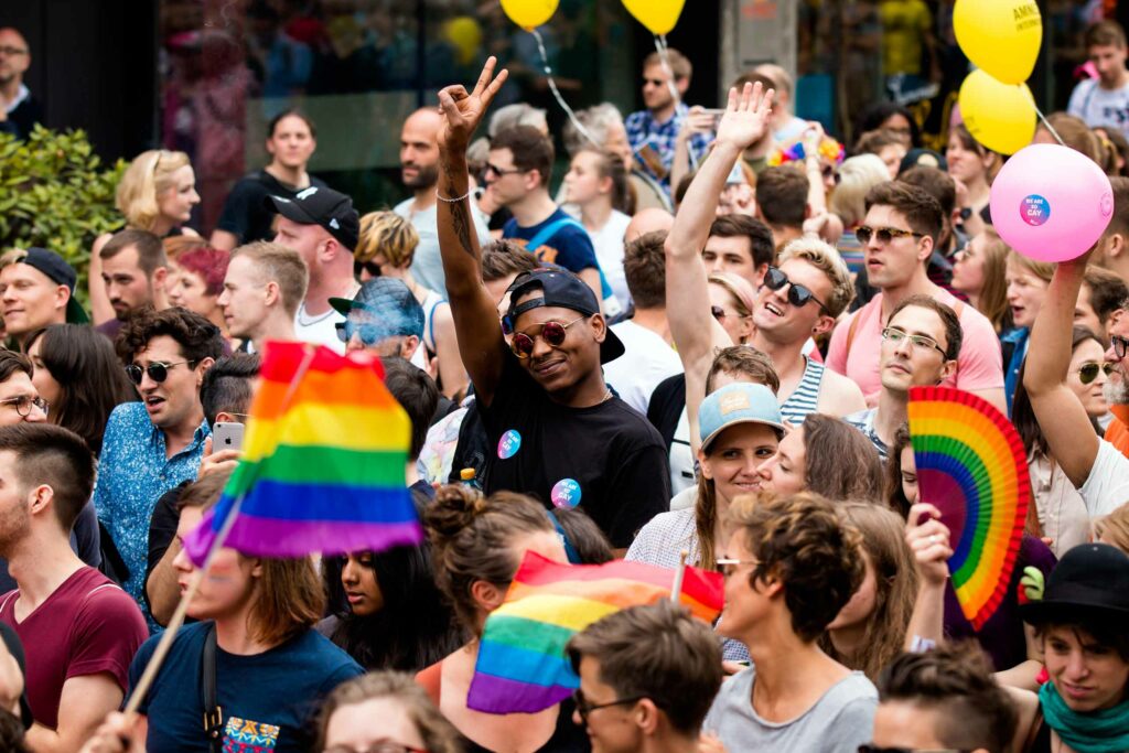 Event goers hold up rainbow flags during Zurich Pride, Switzerland