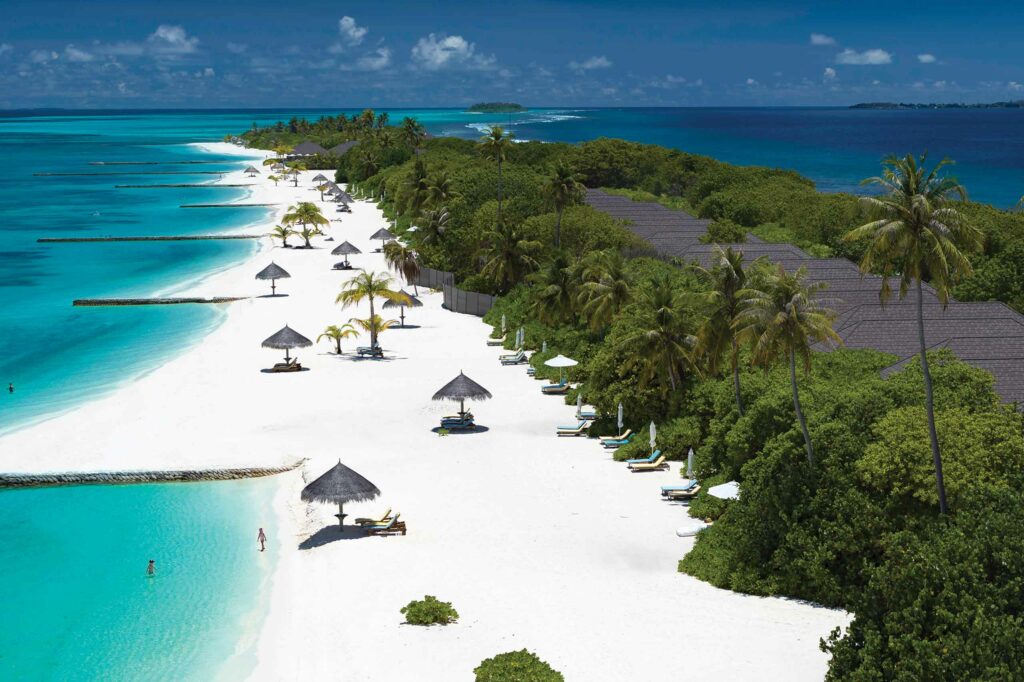 Parasols dot the beach at Atmosphere Kanifushi, Maldives