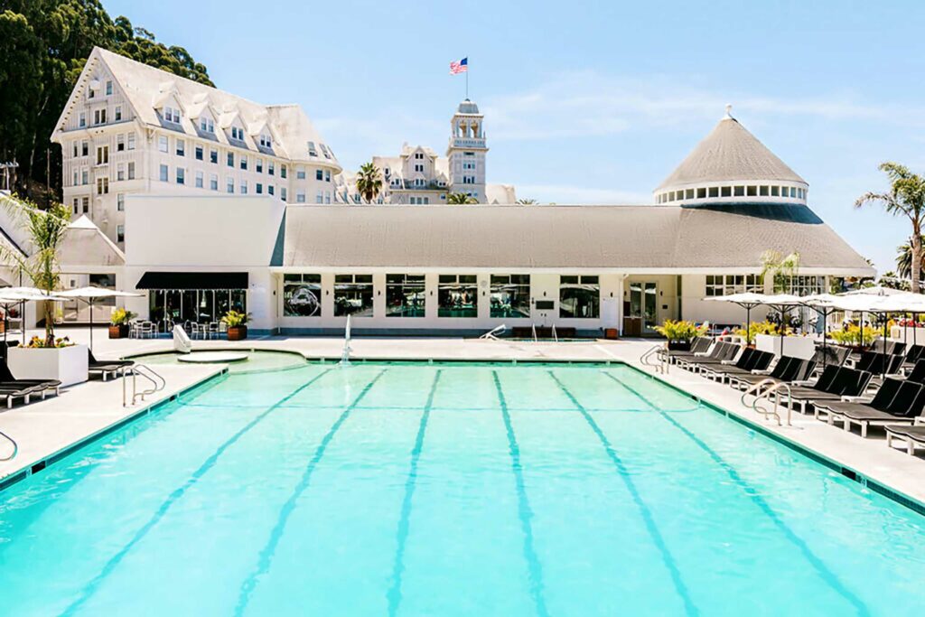 An expansive outdoor pool with poolside loungers