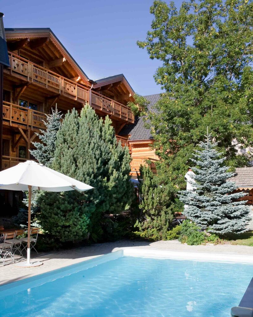 Poolside parasol on a warm summer day at Hôtel Chalet Mounier, Les Deux Alpes, France