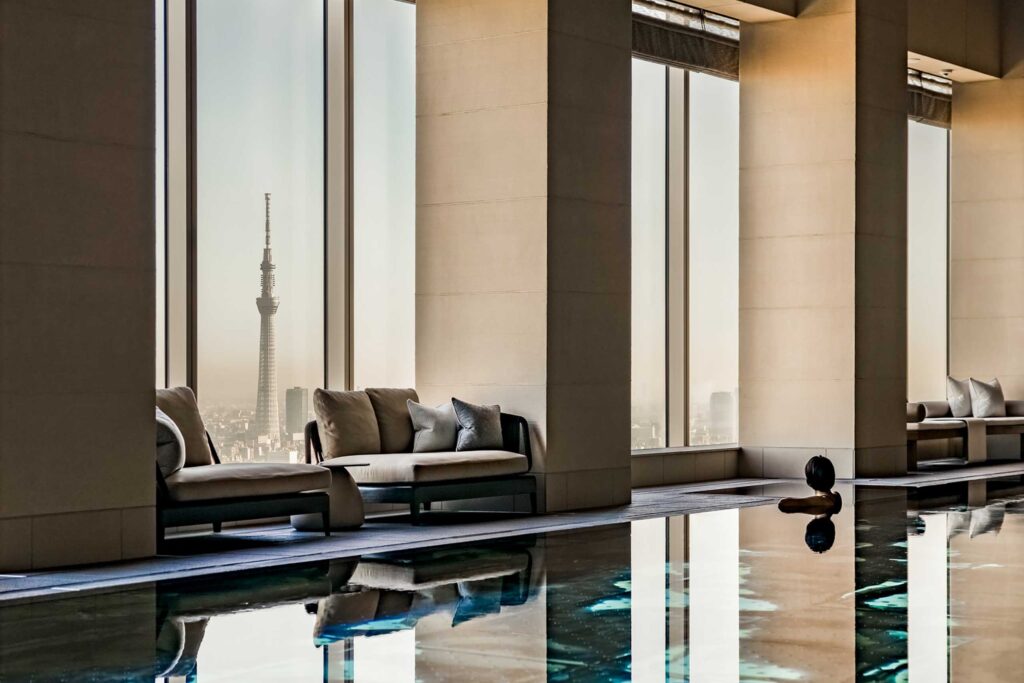 Person in pool overlooking Tokyo Skytree at the Four Seasons Otemachi