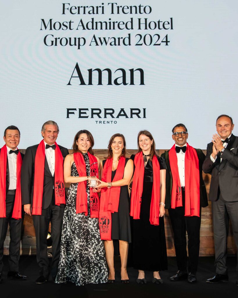 The team of Aman Resorts, winners of The World's 50 Best Hotels 2024 celebrate on stage at London's Guildhall