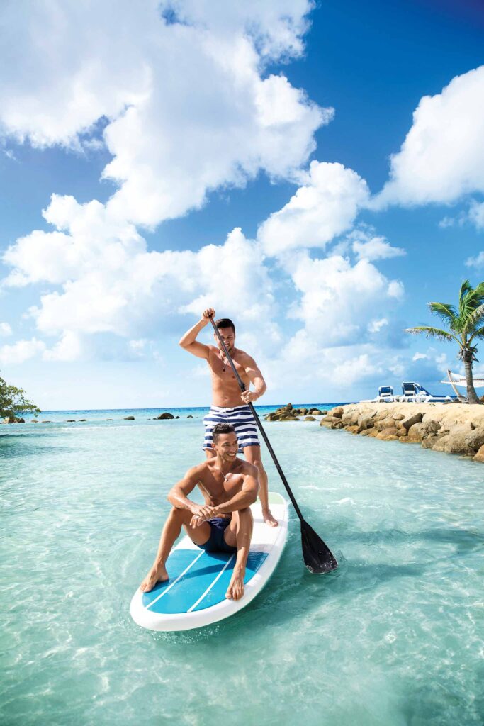 Two men paddleboarding in the Caribbean