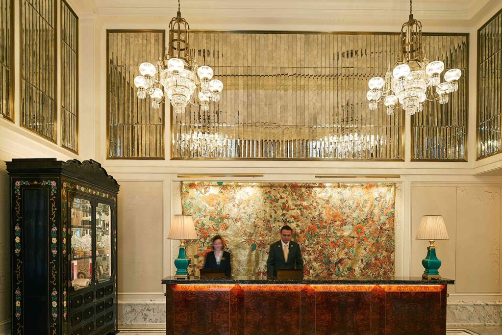 Two guests relations staff in the lobby of the Fifth Avenue Hotel, New York City