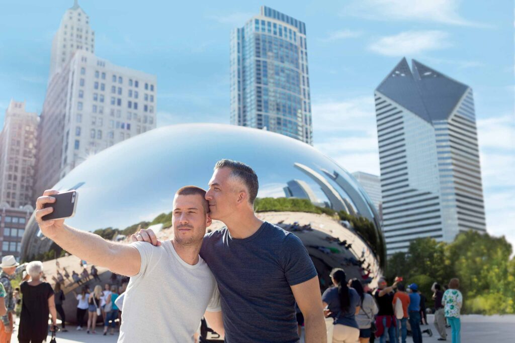 Gay travellers take a selfie in front of the Bean in Chicago Illinois