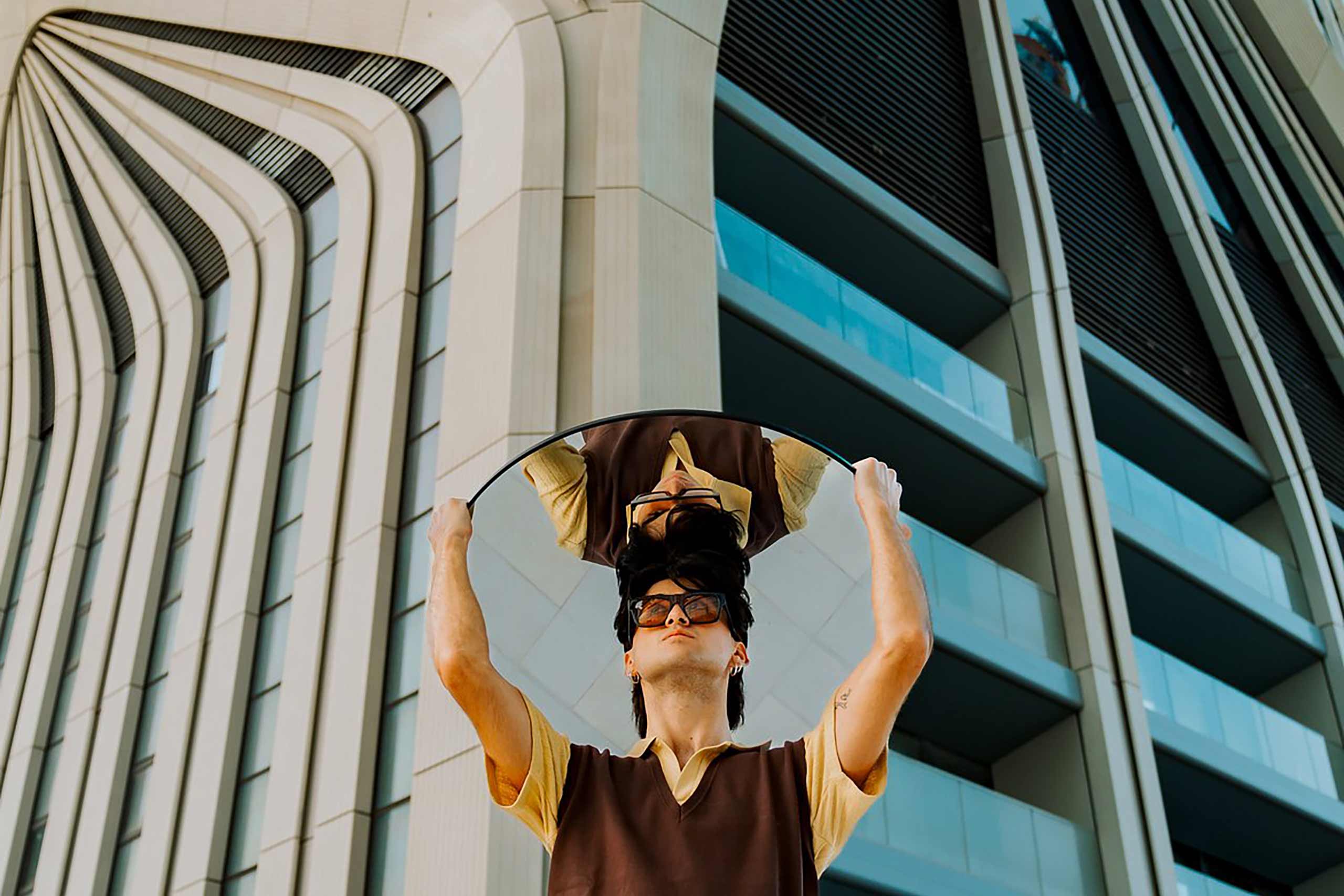 Man standing with mirror outside ME by Melia Malta at the Mercury Tower, a Meliá Hotels International hotel