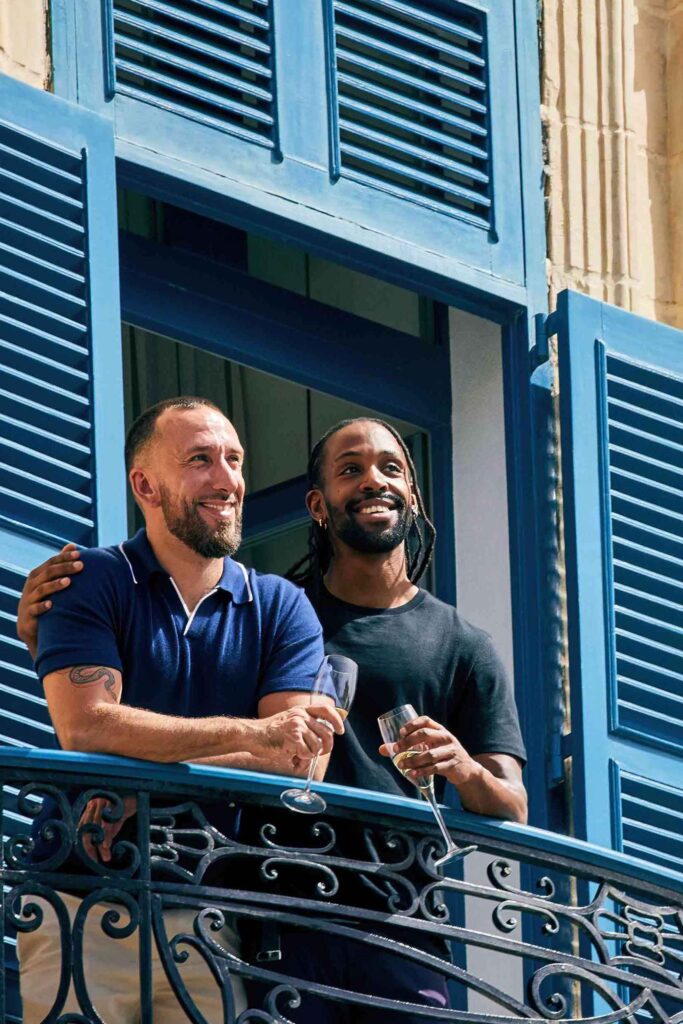 Gay couple on a balcony in Malta