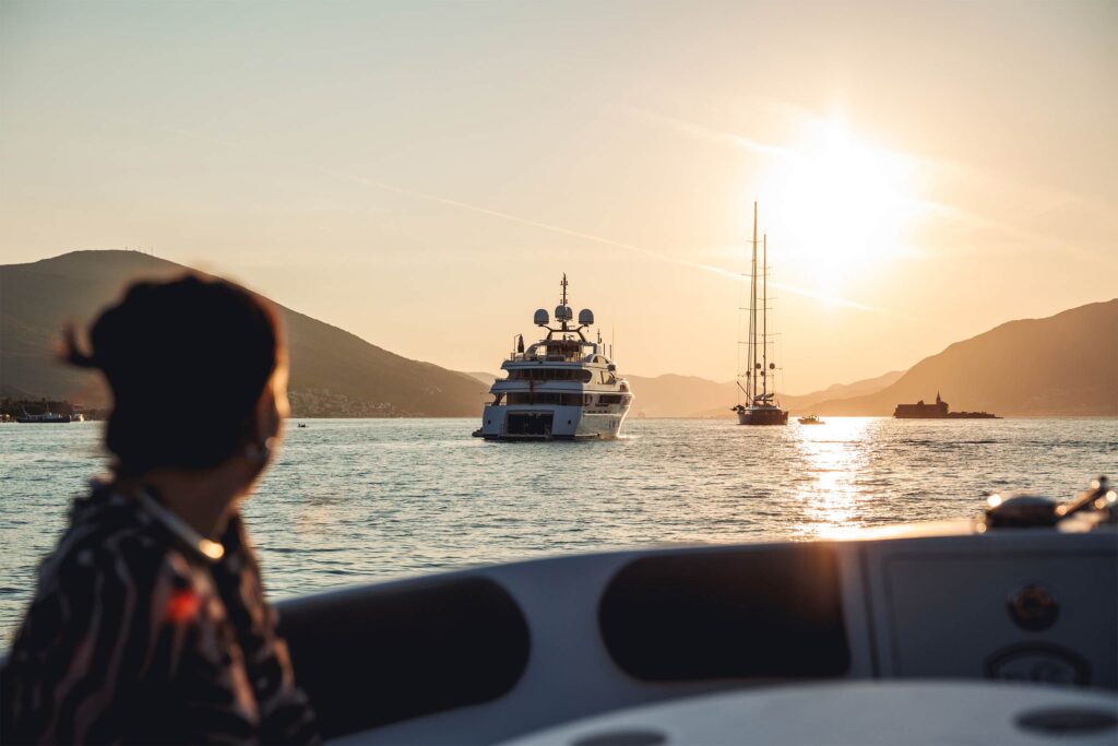 A woman admiring a yacht on the Pacific coast of Mexico.