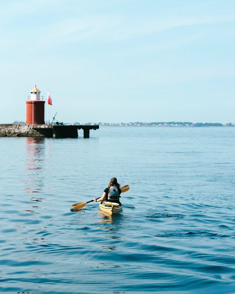 A traveller in a kayak on a fjord in Ålesund, Norway