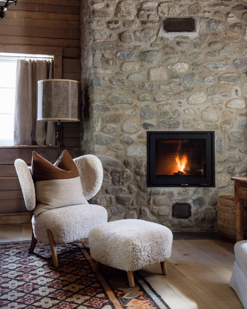 A cosy seat by a fireplace in a suite at Hotel Union Øye, Norangsfjorden, Norway