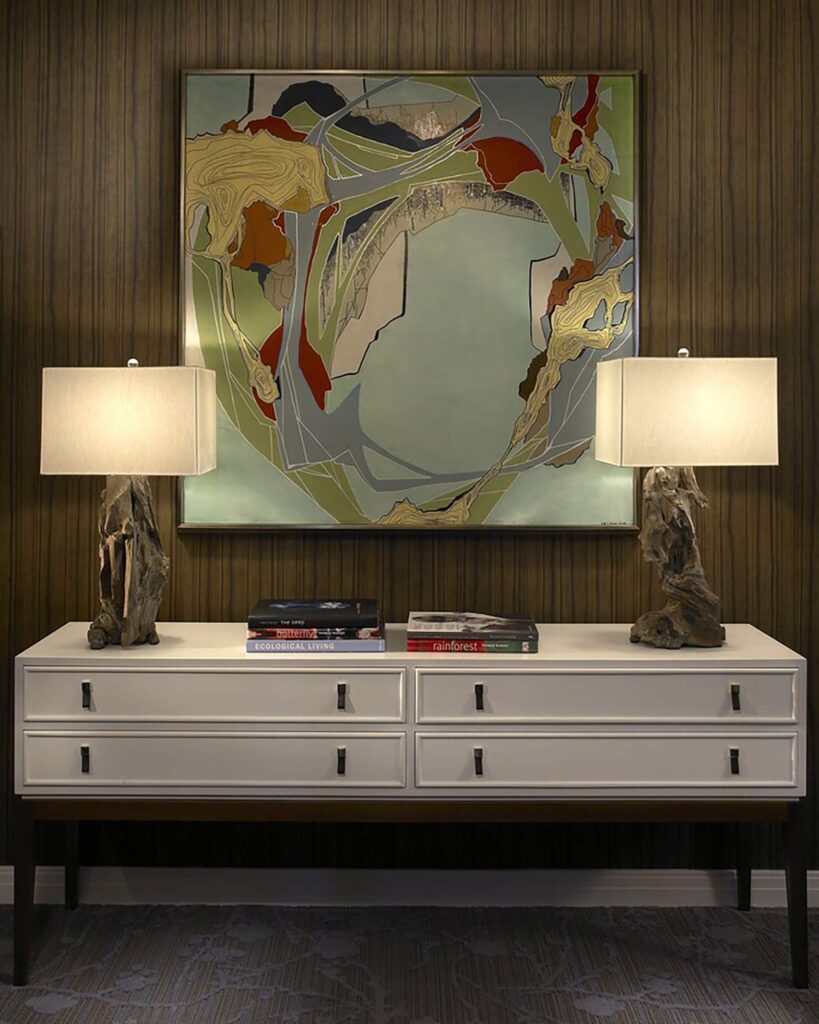 An artwork is framed by table lamps on a sideboard at the Kimpton Hotel Palomar Philadelphia, Philadelphia, Pennsylvania, USA