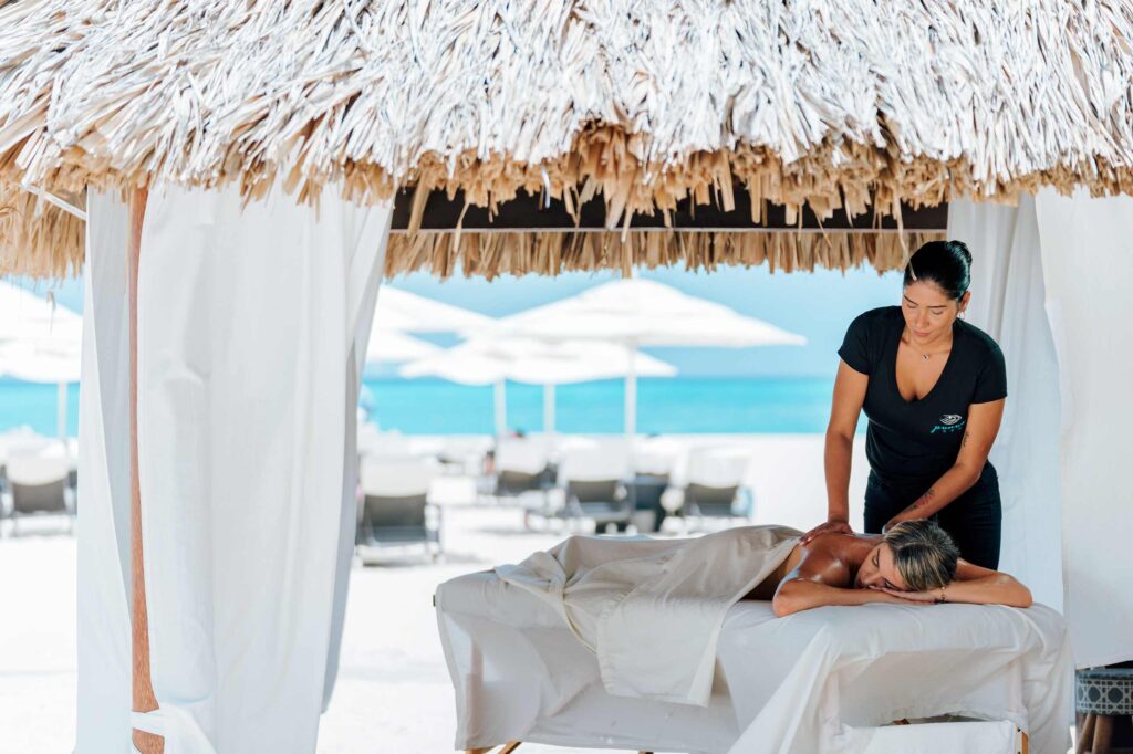 A guest receives a massage in a beach cabana at Bucuti & Tara Beach Resort, Eagle Beach, Aruba