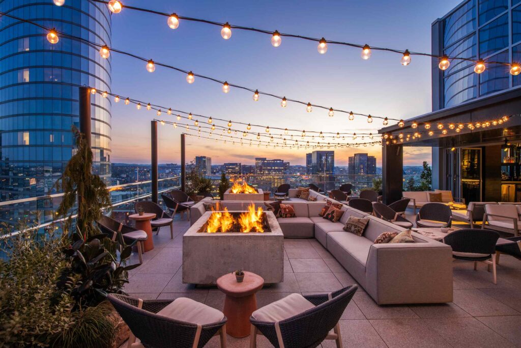 Sun sets over the rooftop bar at 1 Hotel Nashville, Nashville, Tennessee, USA